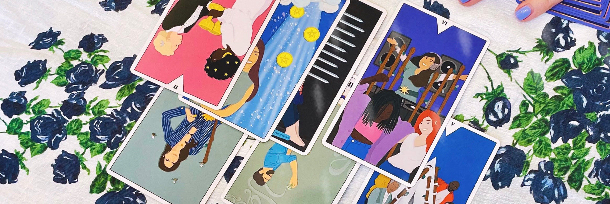 Collection of illustrated tarot cards on a floral background