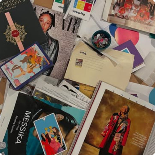 Collection of magazines, cards, and other items on a surface